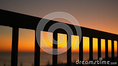 Sunset by the sea on the embankment through the bars of the fence. Sunset by the sea on the embankment through the bars of the fence stock video Sunset by the sea on the embankment through the bars of the fence. Sunset by the sea on the embankment through the bars of the fence stock video