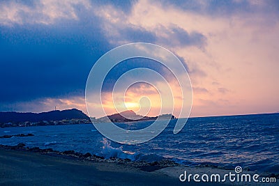 Sunset Sea Perspective from the Shoreline, Beautiful Mountain and Ocean view Landscape, Shimmering Twilight with blue and dark col Stock Photo