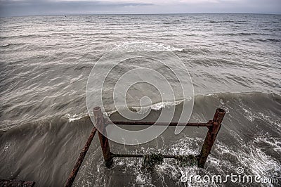 Sunset at the sea shore of a beach with rocks and stormy waves, beautiful seascape at Caspian sea Absheron, Azerbaijan Novkhani Stock Photo