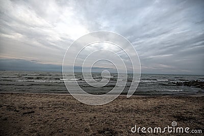 Sunset at the sea shore of a beach with rocks and stormy waves, beautiful seascape at Caspian sea Absheron, Azerbaijan Novkhani Stock Photo