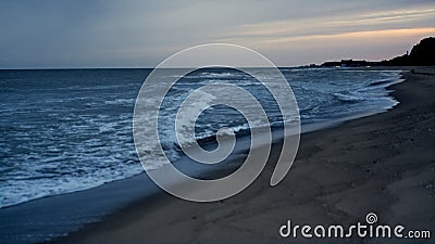 Sunset sea waves crashing beautiful sand beach. Majestic dusk on ocean landscape Stock Photo