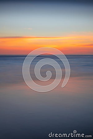 Sunset seascape. Slow shutter speed. Colorful sky. Amazing water reflection. Nature and environment background. Soft focus. Silky Stock Photo