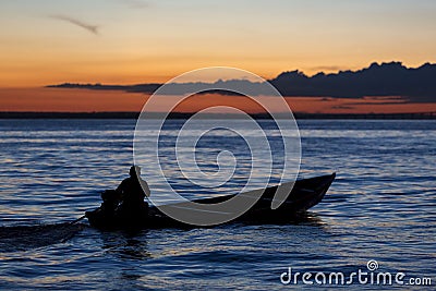 Sunset and silhouette on boat cruising the Amazon River, Brazil Stock Photo