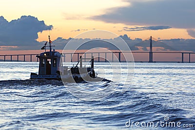 Sunset and silhouette of boat cruising the Amazon River, Brazil Editorial Stock Photo