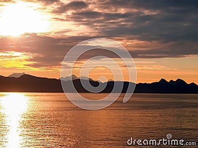 Sunset and silhouette distant hills and land in Alaska Stock Photo