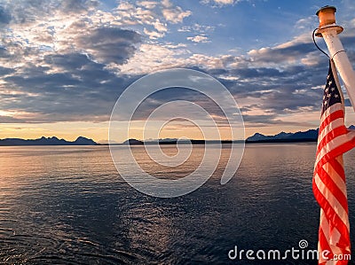 Sunset and silhouette distant hills and land in Alaska Stock Photo