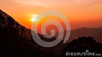 Sunset in the silhouette mountains Stock Photo