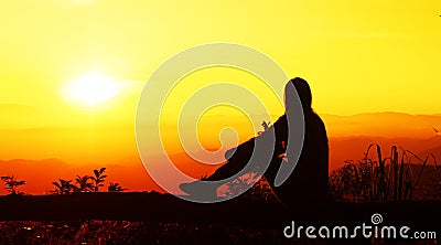 Sunset silhouette Young woman feeing sad looking sunset Stock Photo