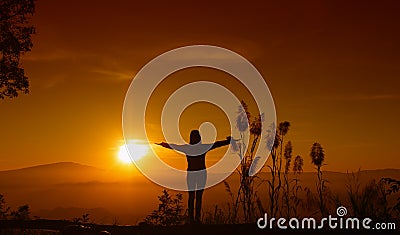 Sunset silhouette Young woman feeling to Freedom and Relax Stock Photo
