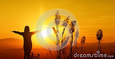 Sunset silhouette Young woman feeling to Freedom and Relax Stock Photo
