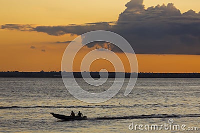 Sunset and silhouettes on boat cruising the Amazon River, Brazil Stock Photo