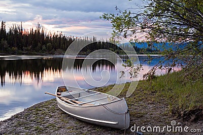 Sunset sky and canoe at Teslin River Yukon Canada Stock Photo