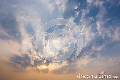 sunset sky with rays of light shining down pass clouds and sky Stock Photo