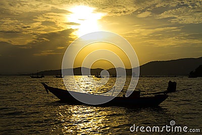 Sunset and small boat Stock Photo