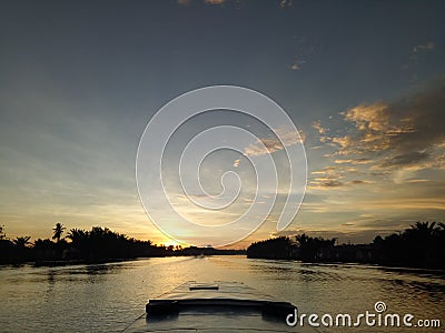 Sunset at small river with small boad Stock Photo