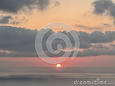 Sea, island Sun and clouds, beautiful coloration of the setting sun Stock Photo