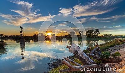 Sunset storks & the river Stock Photo