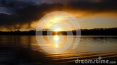 Sunset Storm Clouds Over Lake Pine Trees Wilderness Stock Photo