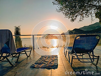 Sunset sunbed pool view chair parasol Stock Photo