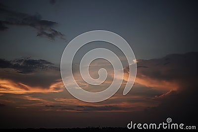 Sunset or sunrise sky. Dense clouds backlit by pink sunlight in the evening or morning sky Stock Photo