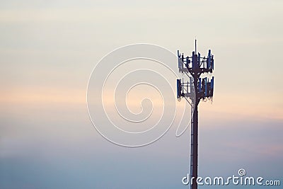 Sunset and Tall mast with cellular antenna Stock Photo