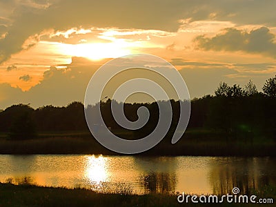 Sunset thunderstorm reflected in the Stock Photo