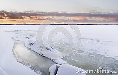 Sunset time next to icy lake Stock Photo