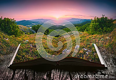 Sunset in a valley on the pages of an open book Stock Photo