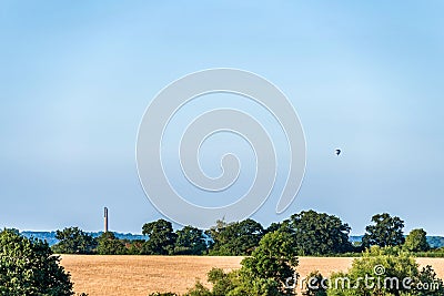 Sunset view British landscape near Northampton with National lift tower and flying baloon Stock Photo