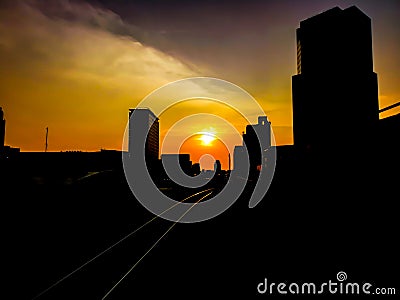 The silhouette of the building and tracks of BTS in the evening, Sunset view in Bangkok, Thailand Stock Photo