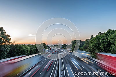 Sunset view heavy traffic moving at speed on UK motorway in England Stock Photo
