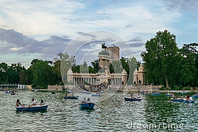Sunset view in the Lake of El Retiro Park where many visitors sail with their boats on a beautiful afternoon. Editorial Stock Photo