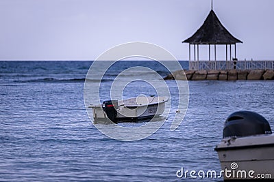 Sunset view of a rescue boat docked off the coast. Stock Photo