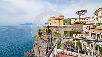 Sunset view of rocky seafront with hotels in Sorrento, Italy Editorial Stock Photo