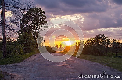 sunset in a village in Latvia road field clouds sun beautiful sunset2 Stock Photo