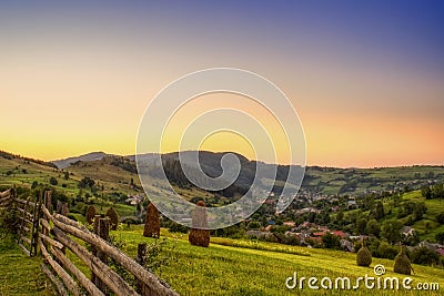 Sunset in a village between mountains, peaceful view Stock Photo
