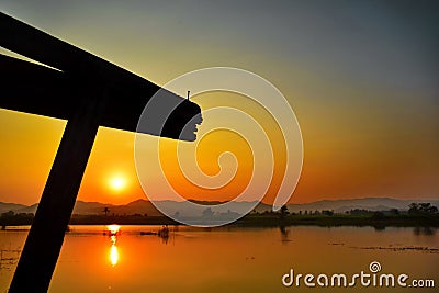 Sunset with water reflection, The wooden beams of the shadows, Stock Photo