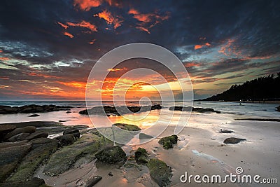 Sunset water wave stone in Lan Hin Khao Beach Mueang Rayong ,Thailand Stock Photo