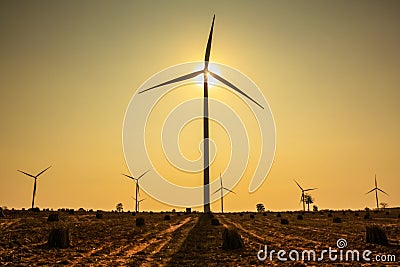 Sunset at wind turbine farm Stock Photo