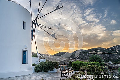 Sunset windmill view during hot summer day on Antiparos island in Cyclades in Greece Stock Photo