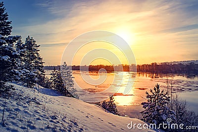 Sunset winter snow nature river horizon landscape. Winter snow forest river sunset view. Sunset winter river snow. Stock Photo