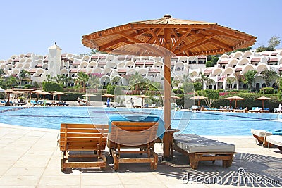 Sunshade and hotel pool Stock Photo