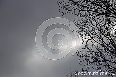 Sunshine behind grey clouds Stock Photo