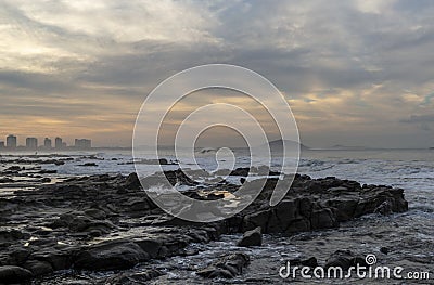 Sunshine Coast in Queensland under a cloudy sky during sunset with skyscrapers in the background Stock Photo