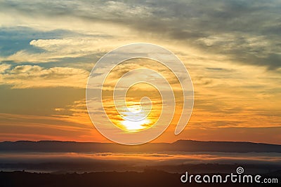 Sunshine on the morning mist with tree and hill Stock Photo