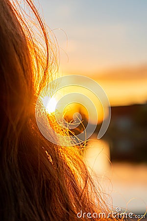 Sunshine shining through long and curly hair during the golden hour. Abstract and calm mood Stock Photo