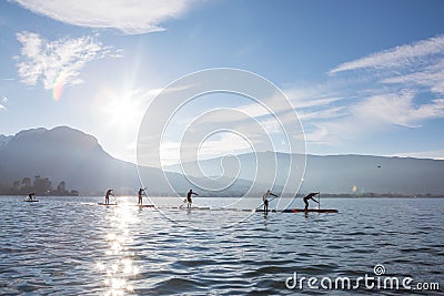 SUP board race in France Alps lake Annecy. Sunny winter day. Professional sport event Editorial Stock Photo