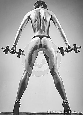 Super body. Sporty female athlete doing fitness workout. Beautiful slim woman`s body. Muscular female body. Stock Photo