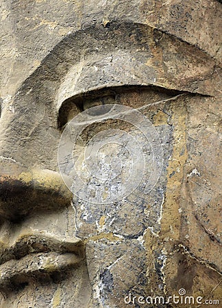 Super close up face Buddha ,Stone old statue of a Buddha in Stock Photo