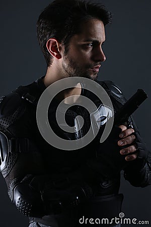 Super cops - Handsome dark haired man holding a gun Stock Photo